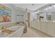 Well-lit bathroom featuring double vanity, bathtub, and neutral tile flooring at 2403 S Atlantic Ave # 501, Daytona Beach Shores, FL 32118