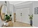 Inviting foyer with a decorative mirror, wooden accents, and neutral colors, creating a warm and welcoming entrance at 2403 S Atlantic Ave # 501, Daytona Beach Shores, FL 32118