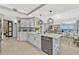 Bright, open kitchen featuring white cabinetry, a spacious island, modern appliances, and seamless transition to living area at 2403 S Atlantic Ave # 501, Daytona Beach Shores, FL 32118