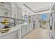 Bright kitchen featuring white cabinets, quartz countertops, and stainless steel appliances at 2403 S Atlantic Ave # 501, Daytona Beach Shores, FL 32118