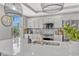 Bright, modern kitchen with stainless steel appliances, gray backsplash, white cabinets, and a large island with a sink at 2403 S Atlantic Ave # 501, Daytona Beach Shores, FL 32118