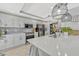 Bright and well-equipped kitchen with stainless steel appliances, white cabinets, and a large island with quartz countertops at 2403 S Atlantic Ave # 501, Daytona Beach Shores, FL 32118