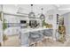 Bright kitchen features white cabinets, a quartz countertop island, modern lighting, and stylish seating for entertaining at 2403 S Atlantic Ave # 501, Daytona Beach Shores, FL 32118
