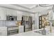 Modern kitchen featuring stainless steel appliances, white cabinets, quartz countertops, and gray subway tile backsplash at 2403 S Atlantic Ave # 501, Daytona Beach Shores, FL 32118
