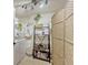 Neutral laundry room showcases a shelving unit with baskets and decorative items plus a folding screen at 2403 S Atlantic Ave # 501, Daytona Beach Shores, FL 32118