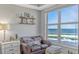 Cozy sitting area off of main bedroom with ocean views, side table and love seat at 2403 S Atlantic Ave # 501, Daytona Beach Shores, FL 32118