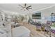 Open living space with a large sectional, egg chair, TV, and views of the kitchen and dining area at 2403 S Atlantic Ave # 501, Daytona Beach Shores, FL 32118
