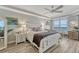 Bright main bedroom with wood floors, ceiling fan, dresser, nightstands, and large windows with ocean view at 2403 S Atlantic Ave # 501, Daytona Beach Shores, FL 32118