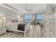 Light and airy main bedroom with wood floors, ceiling fan, large windows overlooking the ocean at 2403 S Atlantic Ave # 501, Daytona Beach Shores, FL 32118