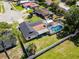 Backyard aerial view featuring a screened in pool, green grass and a white fence at 2506 Bali Cir, Kissimmee, FL 34741