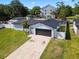Aerial view of a single-story home featuring a long driveway and lush green lawn at 2506 Bali Cir, Kissimmee, FL 34741
