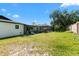 Spacious backyard with an enclosed sunroom and green grass at 2506 Bali Cir, Kissimmee, FL 34741