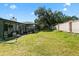 Spacious backyard with enclosed porch, screened pool, and well maintained lawn at 2506 Bali Cir, Kissimmee, FL 34741