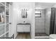 Modern bathroom featuring a vessel sink, updated vanity, and a shower with decorative tiling at 2506 Bali Cir, Kissimmee, FL 34741