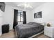 Well-lit bedroom with a ceiling fan, stylish decor, and a comfortable bed with sleek bedside furniture at 2506 Bali Cir, Kissimmee, FL 34741