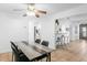 Inviting dining room open to the kitchen with stylish furnishings and a ceiling fan at 2506 Bali Cir, Kissimmee, FL 34741