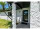 Covered front entrance with stone columns, security door, and well-manicured yard at 2506 Bali Cir, Kissimmee, FL 34741