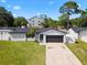 Single-story home featuring a well-maintained lawn, driveway, and attached two-car garage at 2506 Bali Cir, Kissimmee, FL 34741
