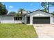Charming single-story home featuring a well-maintained lawn and attached two-car garage at 2506 Bali Cir, Kissimmee, FL 34741
