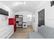 Efficient interior space with red refrigerator, sink, washer, and a futon couch at 2506 Bali Cir, Kissimmee, FL 34741
