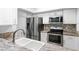 Modern kitchen features stainless steel appliances, granite countertops and mosaic tile backsplash at 2506 Bali Cir, Kissimmee, FL 34741