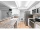 Bright kitchen showcases stainless appliances, a breakfast bar and tiled flooring at 2506 Bali Cir, Kissimmee, FL 34741
