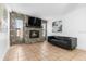 Bright living room features stone fireplace, tile flooring and an abundance of natural light at 2506 Bali Cir, Kissimmee, FL 34741