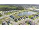 Vibrant aerial view of a Primary-planned community with lush landscaping and a sparkling lake at 2874 Turnstone Run, Harmony, FL 34773