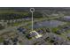 Aerial view of a community near a lake, highlighting a specific home within the neighborhood at 2874 Turnstone Run, Harmony, FL 34773