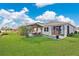 Well-maintained backyard featuring a gazebo with outdoor furniture, a green lawn, and a neatly landscaped garden at 2874 Turnstone Run, Harmony, FL 34773