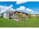 Beautiful backyard showcasing a gazebo with outdoor seating, a green lawn, and a manicured garden area with fencing at 2874 Turnstone Run, Harmony, FL 34773