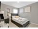 Modern bedroom with neutral tones, stylish decor, and a comfortable bed, creating a serene and inviting atmosphere at 2874 Turnstone Run, Harmony, FL 34773