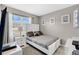 Cozy bedroom featuring a comfortable bed, neutral color palette, and natural light from a window with lovely neighborhood views at 2874 Turnstone Run, Harmony, FL 34773