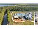 Aerial view of a community pool with ample seating, a playground, and a clubhouse at 2874 Turnstone Run, Harmony, FL 34773