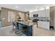 Well-appointed kitchen featuring a center island with barstool seating and elegant pendant lighting at 2874 Turnstone Run, Harmony, FL 34773
