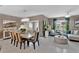 Open-concept living and dining area with elegant chandelier and ample seating space, perfect for entertaining at 2874 Turnstone Run, Harmony, FL 34773