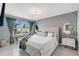 Serene main bedroom featuring a chandelier, ample natural light, and tasteful decor, a private retreat at 2874 Turnstone Run, Harmony, FL 34773