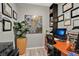 Functional home office space with a wooden desk, built-in shelving, and tastefully decorated walls for a productive atmosphere at 2874 Turnstone Run, Harmony, FL 34773