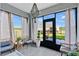 Bright sunroom with large windows, comfortable seating, and elegant lighting, perfect for relaxation and enjoying outdoor views at 2874 Turnstone Run, Harmony, FL 34773