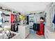 Spacious walk-in closet with custom shelving, island, chandelier, and ample storage space for clothing and accessories at 2874 Turnstone Run, Harmony, FL 34773
