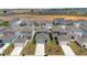 An aerial view shows newly constructed homes with driveways and attached garages in a planned community at 2877 Fitness St, Clermont, FL 34714