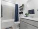 Bathroom featuring gray tiling in shower, matching gray vanity and blue shower curtain at 2877 Fitness St, Clermont, FL 34714