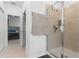 Bathroom featuring a tiled shower with glass doors and a towel rack at 2877 Fitness St, Clermont, FL 34714