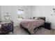 Bright bedroom with a large window, black bed frame, and gray carpeting at 2877 Fitness St, Clermont, FL 34714