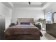 Main bedroom featuring a ceiling fan, large bed with storage, and ensuite bathroom at 2877 Fitness St, Clermont, FL 34714