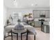 Bright dining area featuring gray cabinets, stainless steel appliances, and a modern table setting at 2877 Fitness St, Clermont, FL 34714