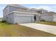 An exterior view presents the house, its driveway, backyard, and garage, set against a clear sky backdrop at 2877 Fitness St, Clermont, FL 34714