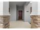 Close-up of the front door with stone pillars and neutral gray accents, a modern and inviting entrance at 2877 Fitness St, Clermont, FL 34714