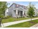 Two-story home with a welcoming front yard, featuring a covered porch with stone accents and green landscaping at 2877 Fitness St, Clermont, FL 34714