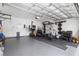 A home garage converted to a gym is well-equipped with weights, machines, and other workout gear at 2877 Fitness St, Clermont, FL 34714